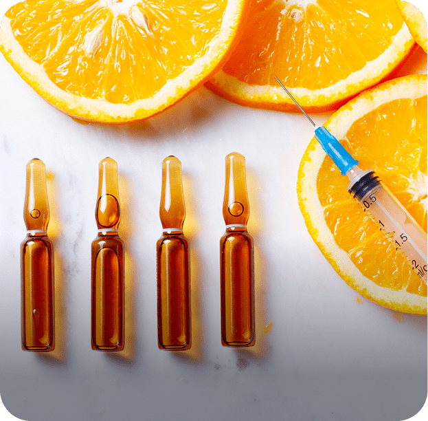 Vitamin C concept with oranges and vials